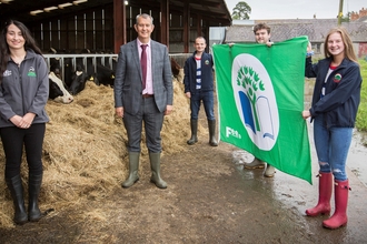 Lisnamurrican YFC receiving their green flag award from Minister Poots