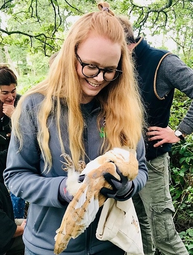 Katy Bell holding a barn owl chick