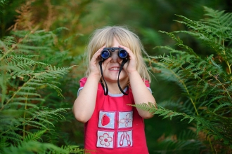Girl looking through binoculars 