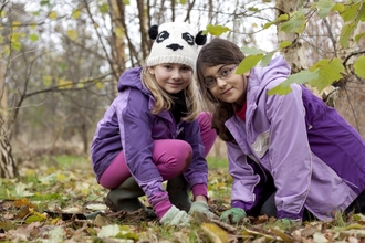 Girls planting bluebells