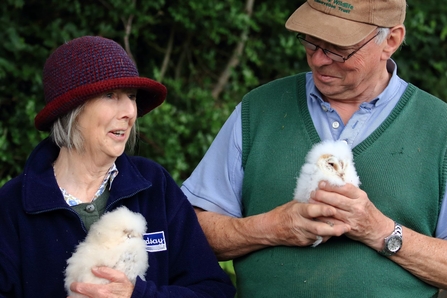 David Sandford and his wife with the baby owls ringed on their farm 