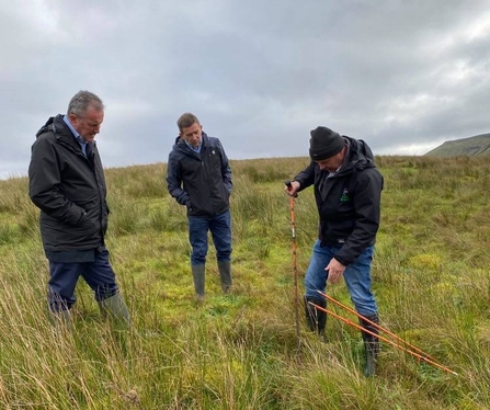 Connor Murphy watching Jim McAdam peat coring on Cuilcagh 