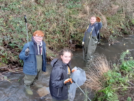 Aaron and volunteers cleaning litter from the stream