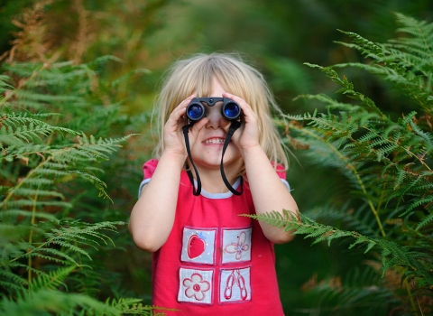 Girl looking through binoculars 