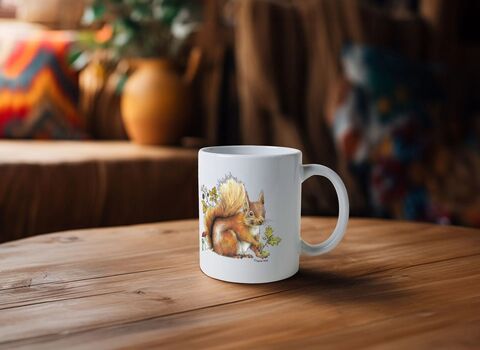 A white Ulster Wildlife red squirrel autumn mug on a wooden table with house plant visible in background
